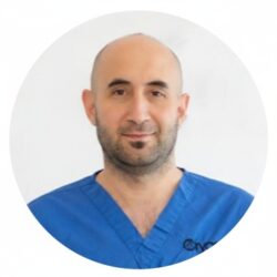 Ritratto di Christodoulos Christodoulou, MSc in Embriologia Clinica, Operations Manager e Senior Embryologist presso la Cryos IVF Clinic a Cipro, con indosso la divisa blu con il logo della clinica.